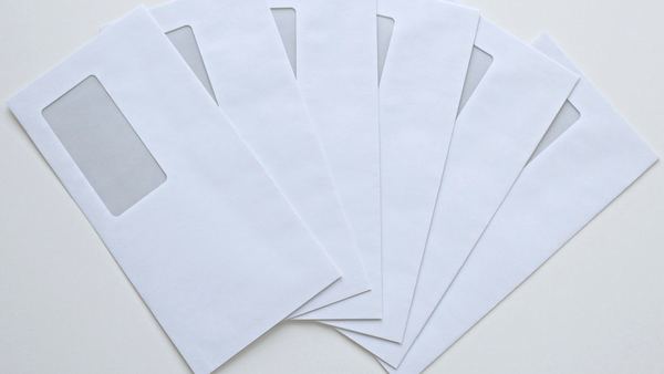 A fan of window envelopes ready for an addressed mailing.