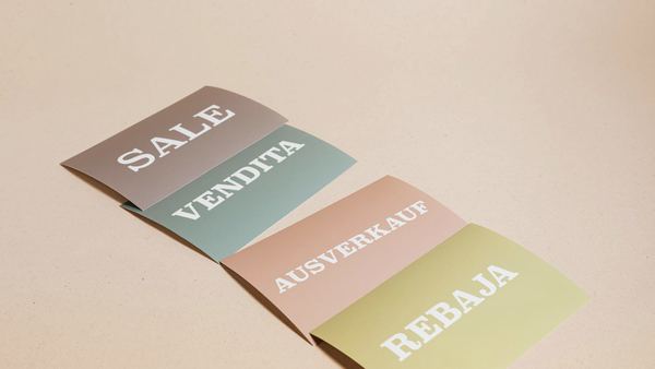 Folded leaflets in several colours laid out on a plain surface.