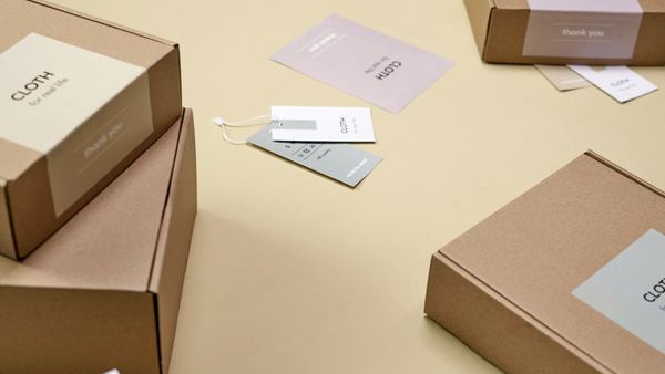 Printed kraft mailer boxes with inserts and cards.
