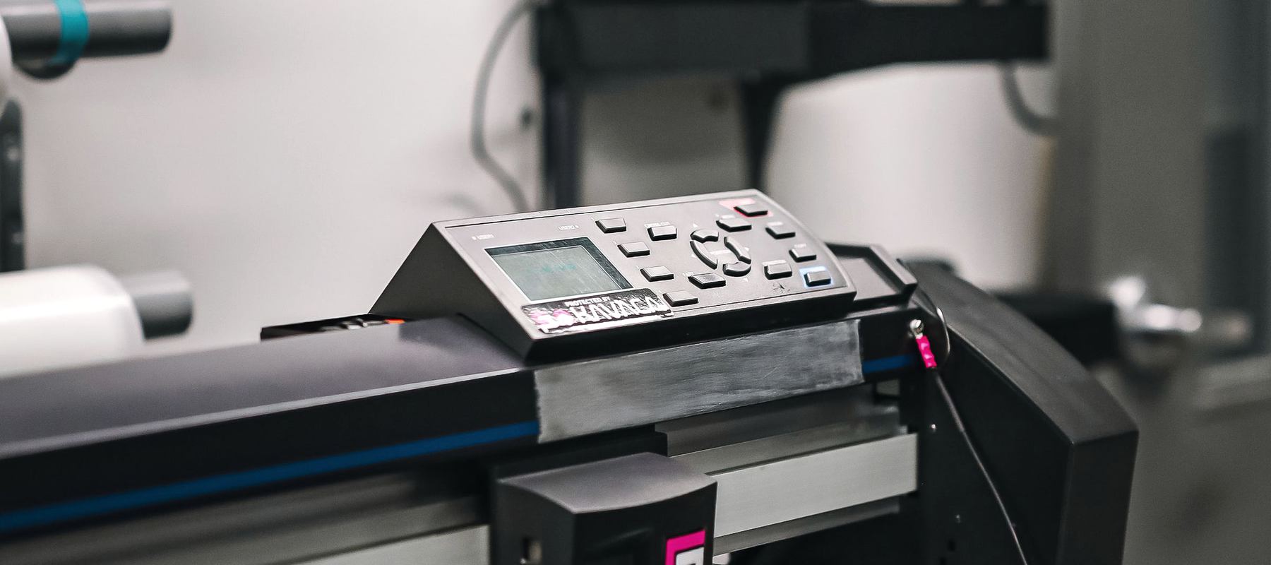 A wide-format printer running a roll of vinyl, used for signage and display work.