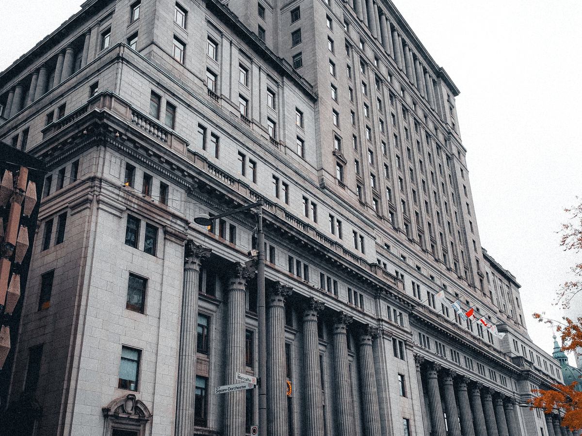 The stone facade and columns of a large civic office building.