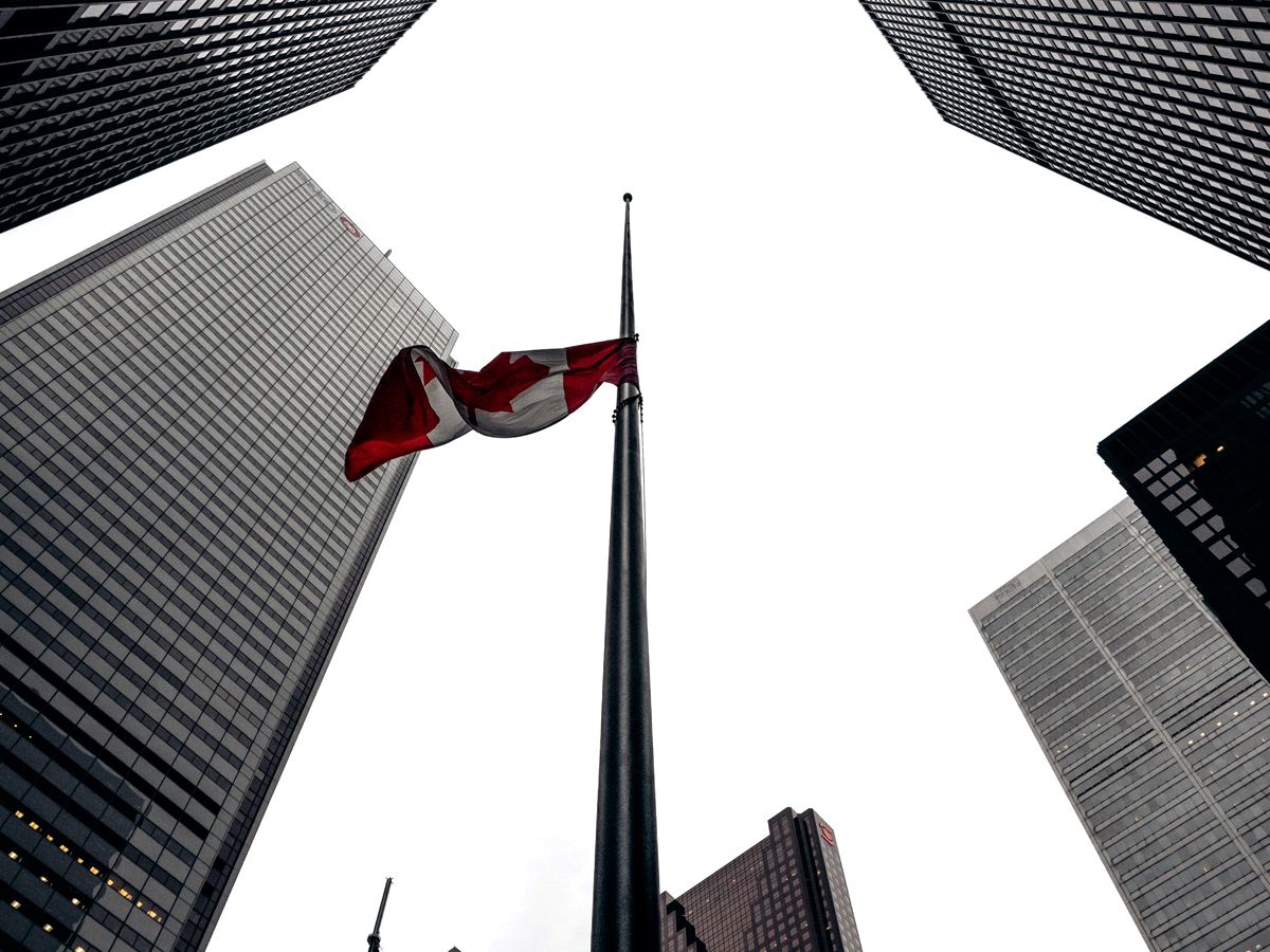 The Canadian flag flying among the office towers of Toronto's financial district.